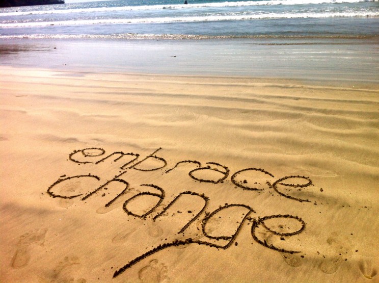 Embrace Change written in the sand at a beach